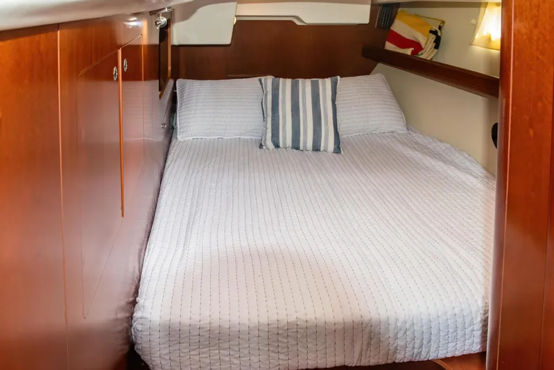  Yacht Photos Pics Cozy cabin interior of 2007 Beneteau Oceanis 523 yacht with striped pillow.