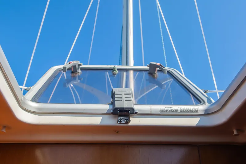  Yacht Photos Pics Hatch view from 2007 Beneteau Oceanis 523 sailboat, showcasing mast and clear blue sky.