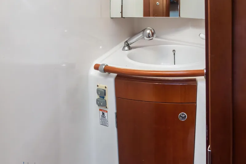  Yacht Photos Pics Bathroom sink area on a 2007 Beneteau Oceanis 523 yacht, featuring wood cabinetry.