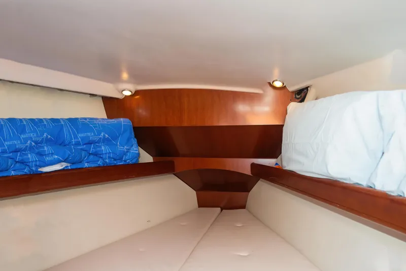  Yacht Photos Pics Cozy cabin interior of 2007 Beneteau Oceanis 523 yacht with wooden accents and bedding.