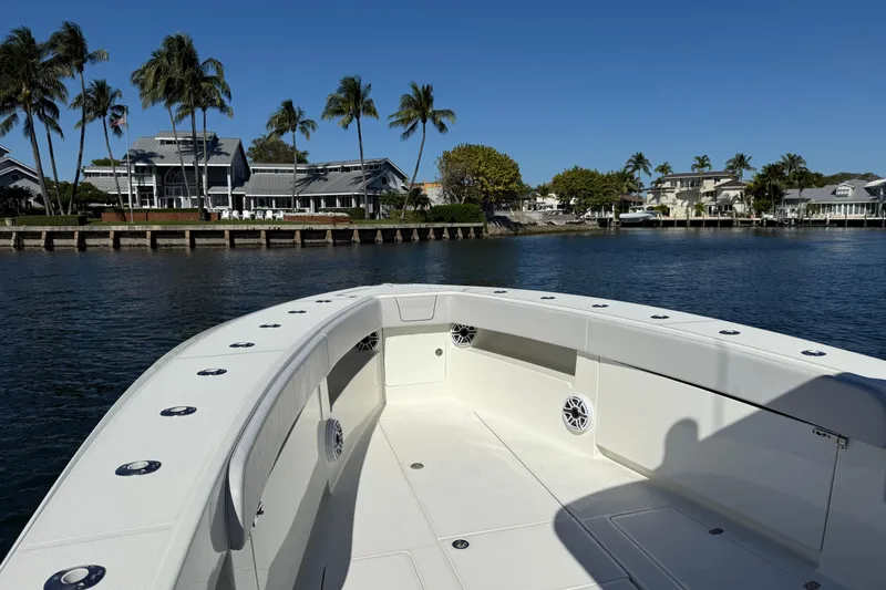  Yacht Photos Pics 2018 SeaVee 390Z boat on calm water near waterfront homes and palm trees.