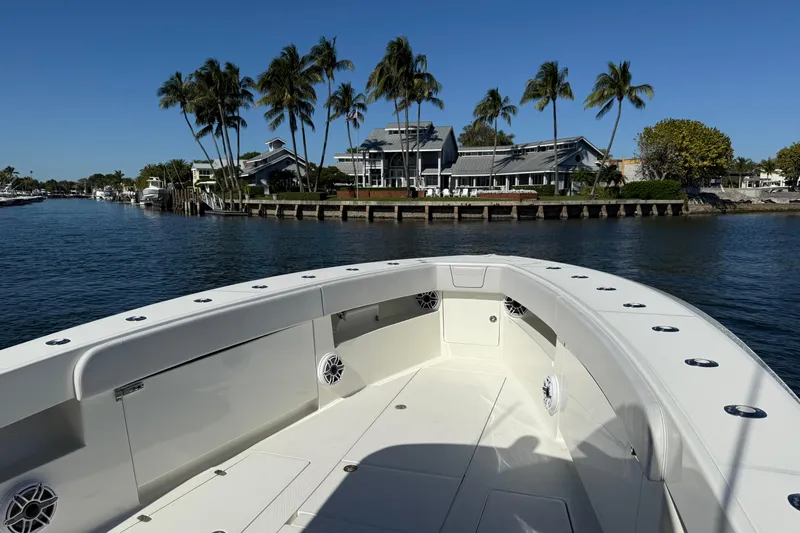  Yacht Photos Pics 2018 SeaVee 390Z boat on water near palm trees and waterfront homes.