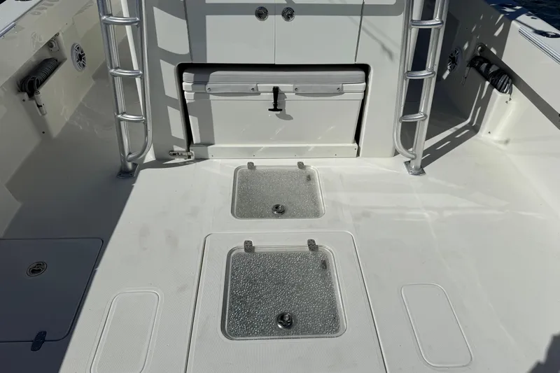  Yacht Photos Pics 2018 SeaVee 390Z boat deck with storage compartments and ladder.