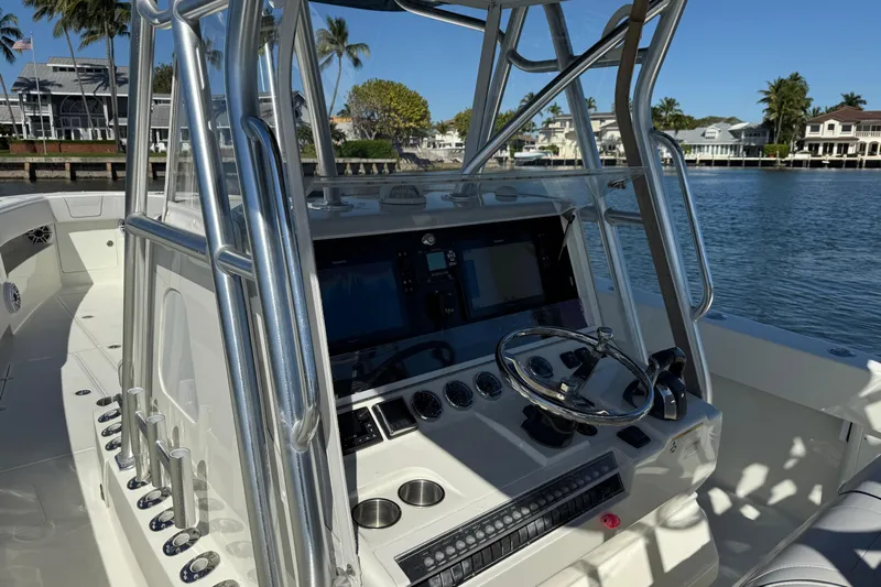 Yacht Photos Pics 2018 SeaVee 390Z boat cockpit with steering wheel, control panel, and waterfront view.