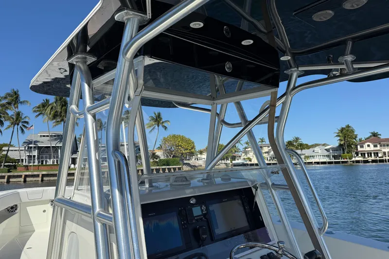  Yacht Photos Pics 2018 SeaVee 390Z boat console with T-top, docked near waterfront homes.