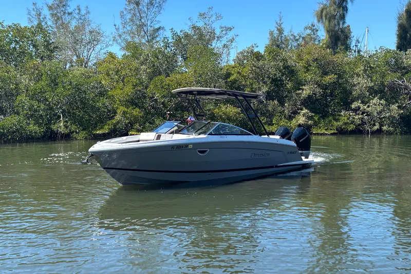  Yacht Photos Pics 2022 Cobalt R8 Outboard boat cruising on a serene river with lush greenery.