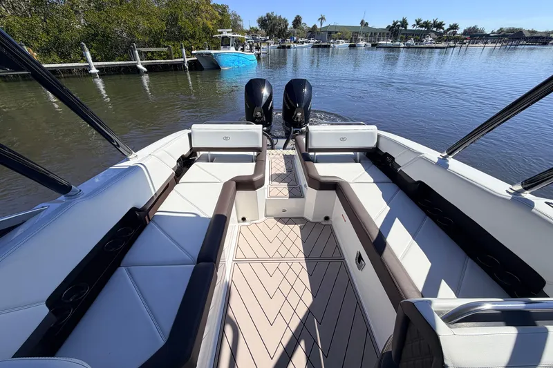  Yacht Photos Pics 2022 Cobalt R8 Outboard boat interior with spacious seating and dual engines on a calm waterway.