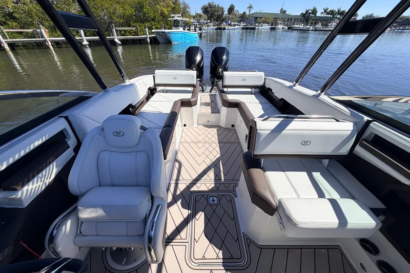  Yacht Photos Pics 2022 Cobalt R8 Outboard boat interior with luxurious seating and modern design on a calm waterway.