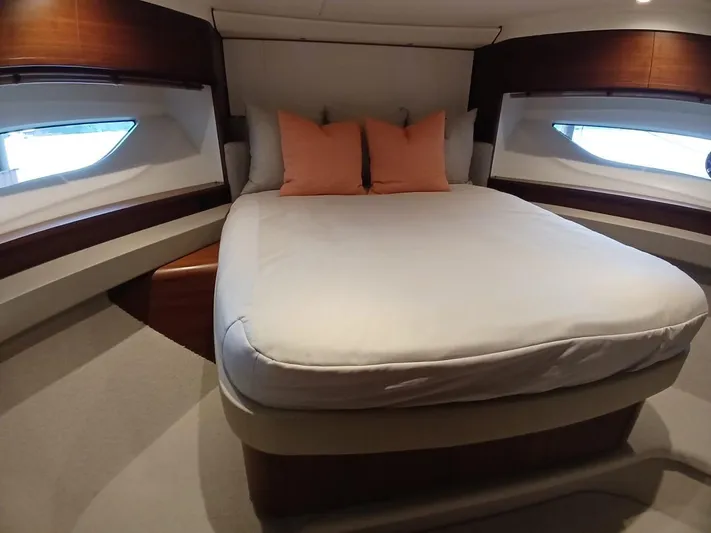 Palmar Yacht Photos Pics Luxurious bedroom interior of 2023 Princess F55 yacht with elegant bedding and modern design.