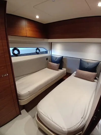 Palmar Yacht Photos Pics Luxurious cabin interior of 2023 Princess F55 yacht with twin beds and elegant wood finish.