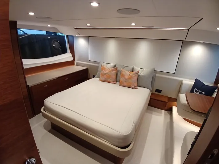 Palmar Yacht Photos Pics Luxurious bedroom interior of 2023 Princess F55 yacht with modern design and cozy bedding.