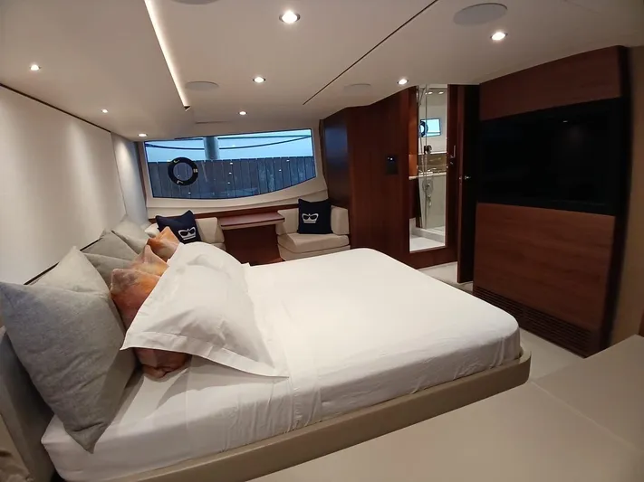 Palmar Yacht Photos Pics Luxurious bedroom interior of 2023 Princess F55 yacht with modern design and elegant furnishings.