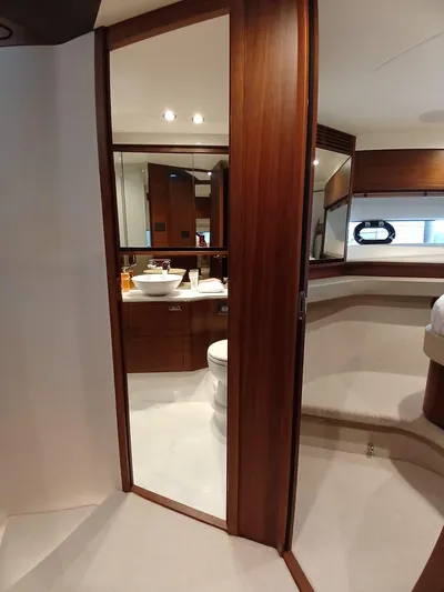 Palmar Yacht Photos Pics Luxurious interior of 2023 Princess F55 yacht, featuring elegant wood finishes and modern bathroom.