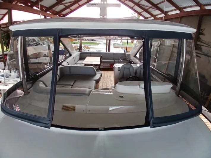 Palmar Yacht Photos Pics 2023 Princess F55 yacht interior with seating and table under a covered dock.