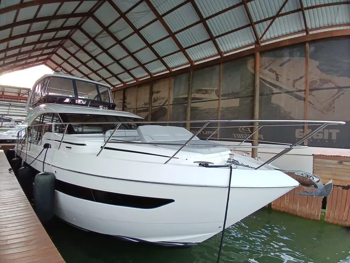 Palmar Yacht Photos Pics 2023 Princess F55 yacht docked in a covered marina.