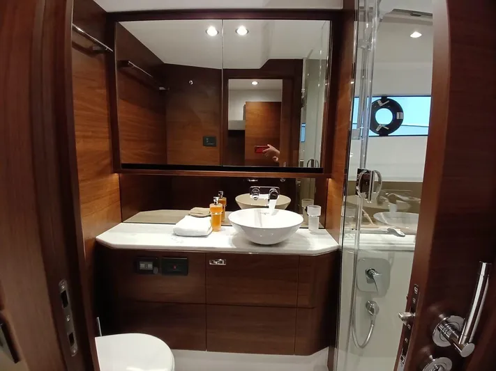 Palmar Yacht Photos Pics Luxurious bathroom in 2023 Princess F55 yacht with wood accents and modern fixtures.