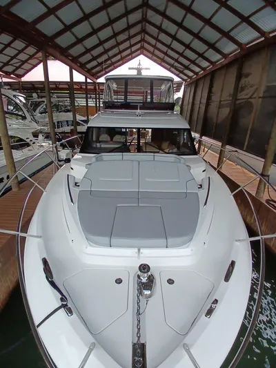 Palmar Yacht Photos Pics 2023 Princess F55 yacht docked under a covered marina, showcasing sleek design and luxury features.