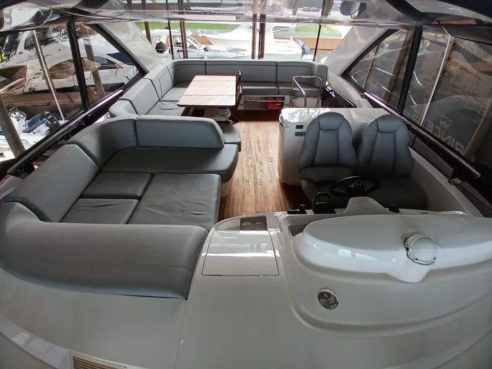 Palmar Yacht Photos Pics Luxurious 2023 Princess F55 yacht interior with spacious seating and elegant wooden flooring.