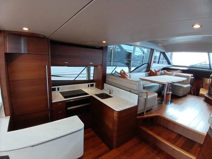 Palmar Yacht Photos Pics Luxurious interior of 2023 Princess F55 yacht with modern kitchen and seating area.