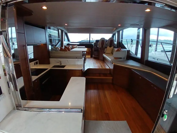 Palmar Yacht Photos Pics Luxurious interior of 2023 Princess F55 yacht with modern kitchen and seating area.