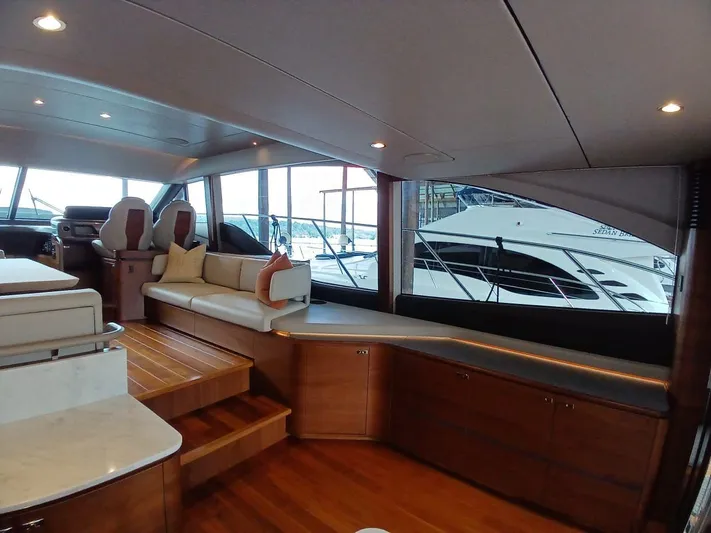 Palmar Yacht Photos Pics Luxurious interior of 2023 Princess F55 yacht with elegant seating and wooden finishes.