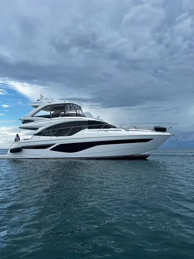 Palmar Yacht Photos Pics 2023 Princess F55 yacht on calm ocean under cloudy sky.