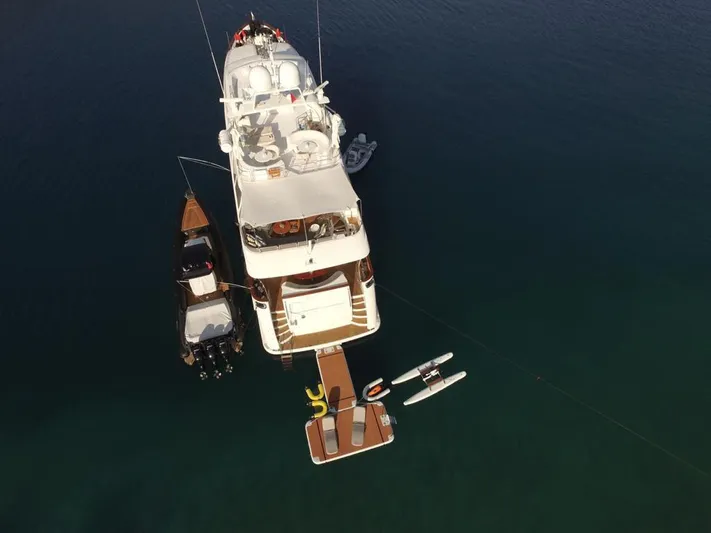 Bdt Yacht Photos Pics Aerial view of 2003 Benetti Classic 115 yacht with attached watercraft and floating dock.