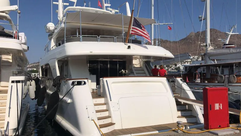 Bdt Yacht Photos Pics Benetti Classic 115 yacht, 2003 model, docked at marina with American flag.
