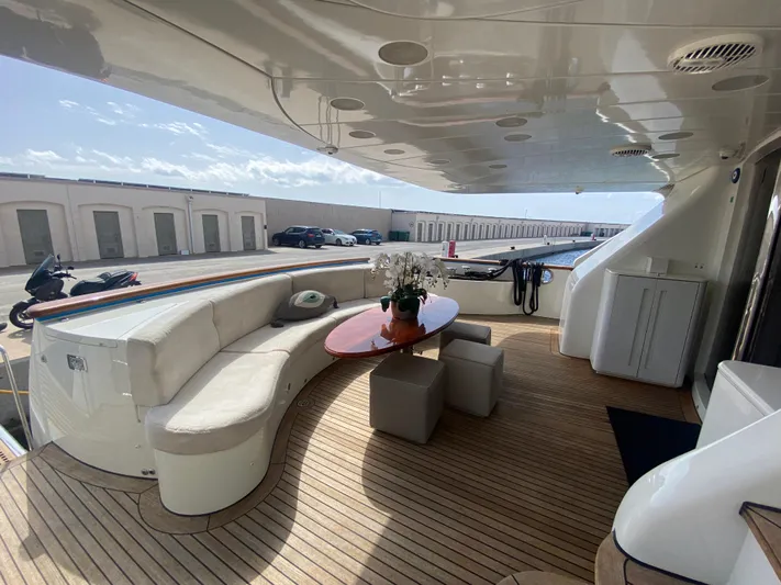 Bdt Yacht Photos Pics Luxurious deck of 2003 Benetti Classic 115 yacht with elegant seating and table.