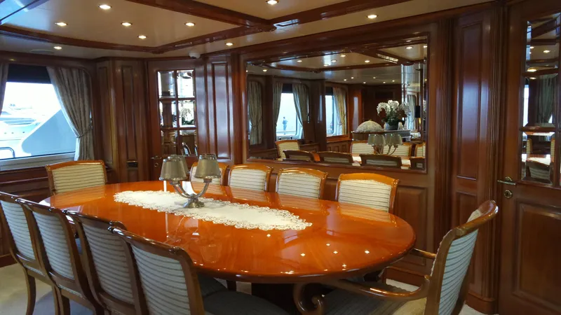 Bdt Yacht Photos Pics Luxurious dining area on a 2003 Benetti Classic 115 yacht with elegant wood finishes.