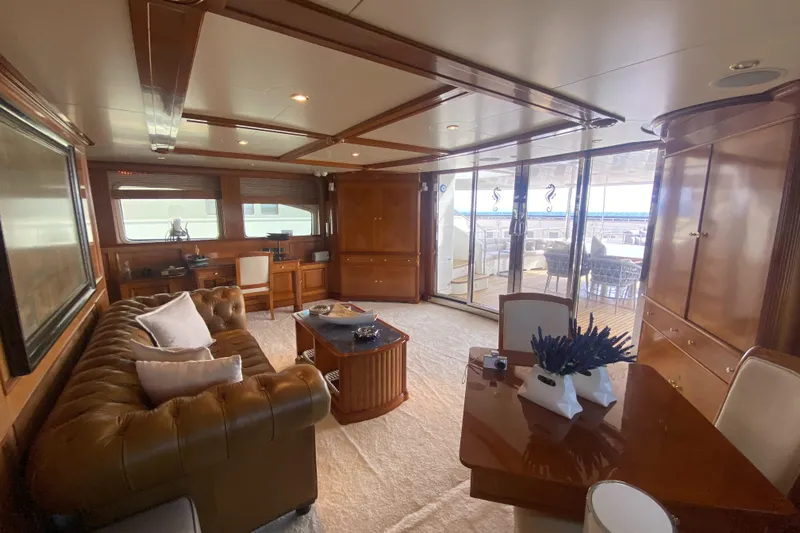 Bdt Yacht Photos Pics Luxurious interior of 2003 Benetti Classic 115 yacht with elegant wood finishes and plush seating.