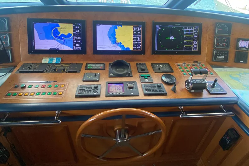 Bdt Yacht Photos Pics Control panel of a 2003 Benetti Classic 115 yacht with navigation screens and instruments.