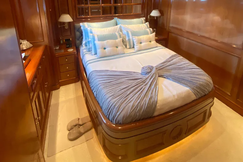 Bdt Yacht Photos Pics Luxurious bedroom on 2003 Benetti Classic 115 yacht with elegant wood paneling and plush bedding.