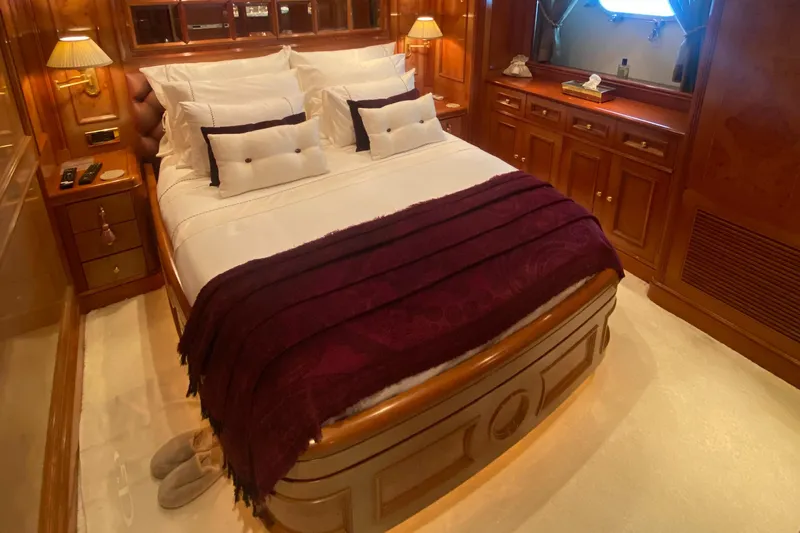 Bdt Yacht Photos Pics Luxurious bedroom on 2003 Benetti Classic 115 yacht with elegant wood paneling and plush bedding.