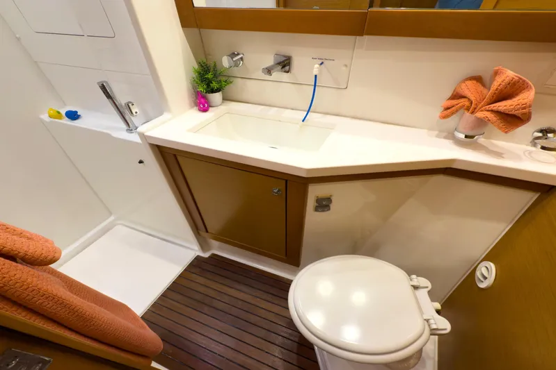  Yacht Photos Pics Luxurious bathroom in 2012 Lagoon 450F yacht with modern fixtures and wooden flooring.