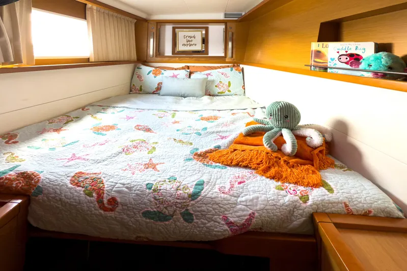  Yacht Photos Pics Cozy bedroom in 2012 Lagoon 450F yacht with nautical-themed bedding and plush octopus toy.