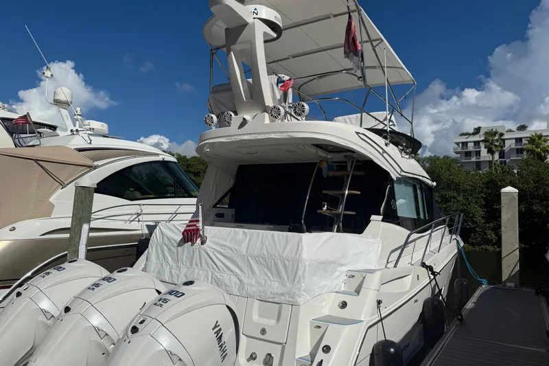  Yacht Photos Pics 2023 Regal 38 FXO yacht docked with Yamaha outboard engines, under a clear blue sky.