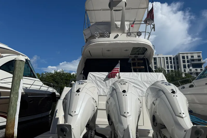  Yacht Photos Pics 2023 Regal 38 FXO yacht with triple outboard engines docked at marina.