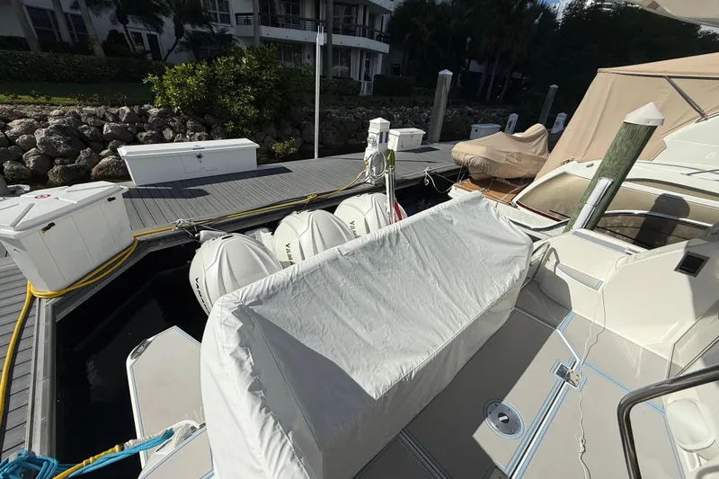  Yacht Photos Pics 2023 Regal 38 FXO yacht docked, covered seating, outboard engines, and marina setting.