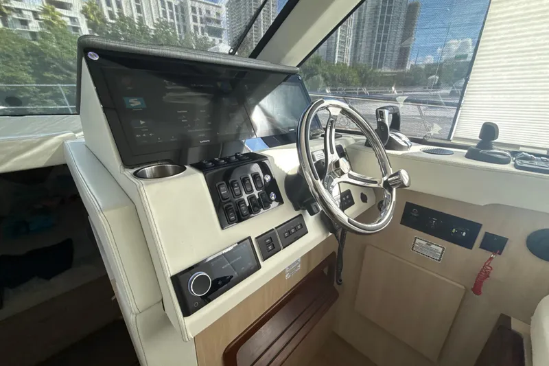  Yacht Photos Pics 2023 Regal 38 FXO helm with modern controls and sleek steering wheel.