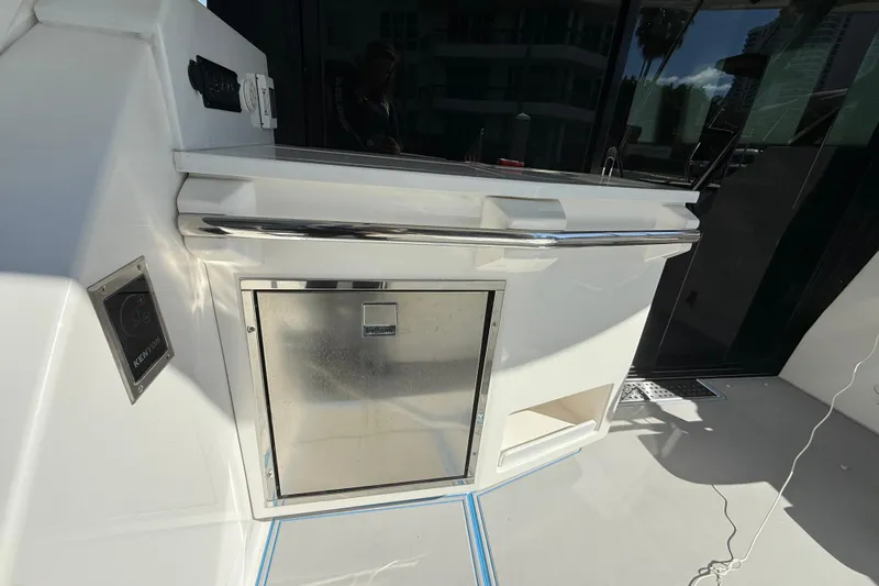  Yacht Photos Pics 2023 Regal 38 FXO yacht kitchenette with stainless steel appliances and sleek design.