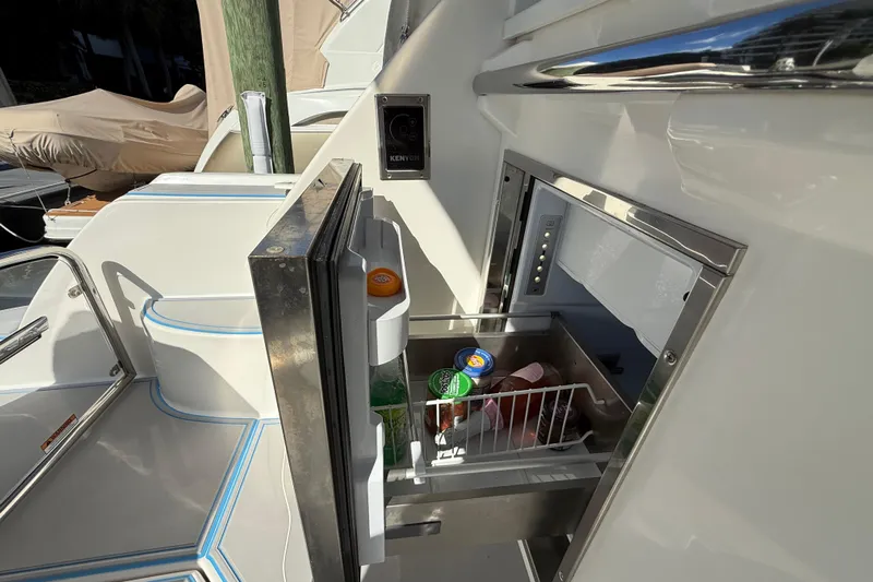  Yacht Photos Pics 2023 Regal 38 FXO yacht with open mini fridge, stocked with drinks and snacks.