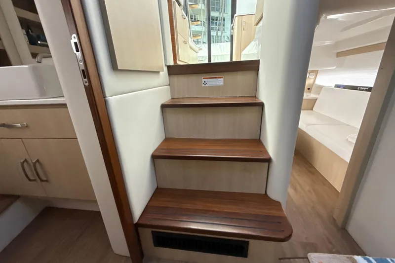  Yacht Photos Pics Interior stairs of 2023 Regal 38 FXO yacht, featuring wooden steps and modern design.