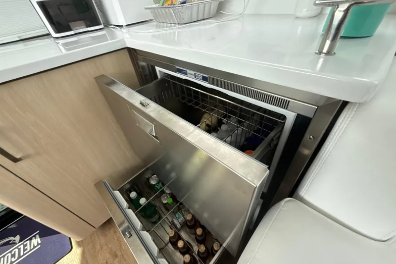  Yacht Photos Pics Stainless steel drawer fridge on 2023 Regal 38 FXO yacht, stocked with beverages.