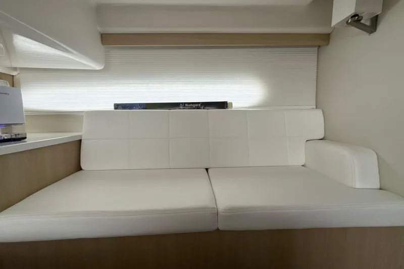  Yacht Photos Pics 2023 Regal 38 FXO interior with white cushioned seating and modern design.