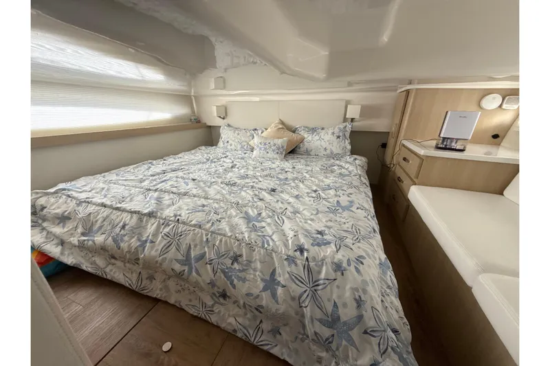  Yacht Photos Pics Luxurious cabin interior of 2023 Regal 38 FXO yacht with floral bedding.