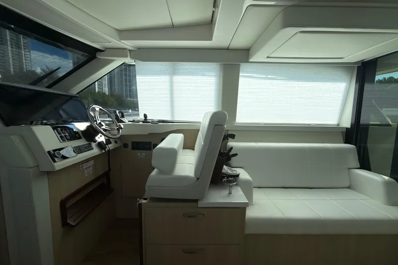  Yacht Photos Pics Interior of 2023 Regal 38 FXO yacht with modern helm and white seating.