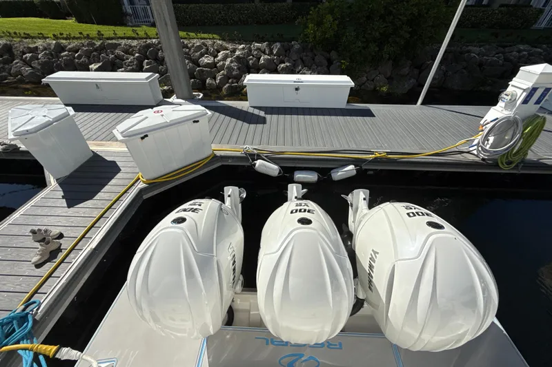  Yacht Photos Pics 2023 Regal 38 FXO boat with triple Yamaha 300 engines docked at a marina.