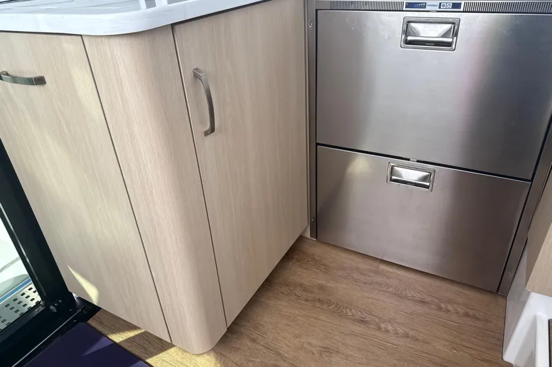  Yacht Photos Pics 2023 Regal 38 FXO interior with wood cabinetry and stainless steel drawers.