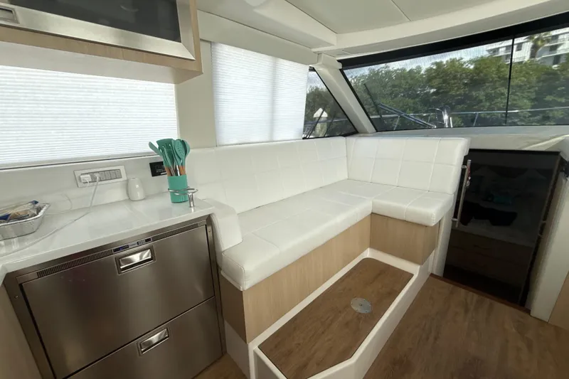  Yacht Photos Pics Luxurious interior of 2023 Regal 38 FXO yacht with white seating and modern kitchen.